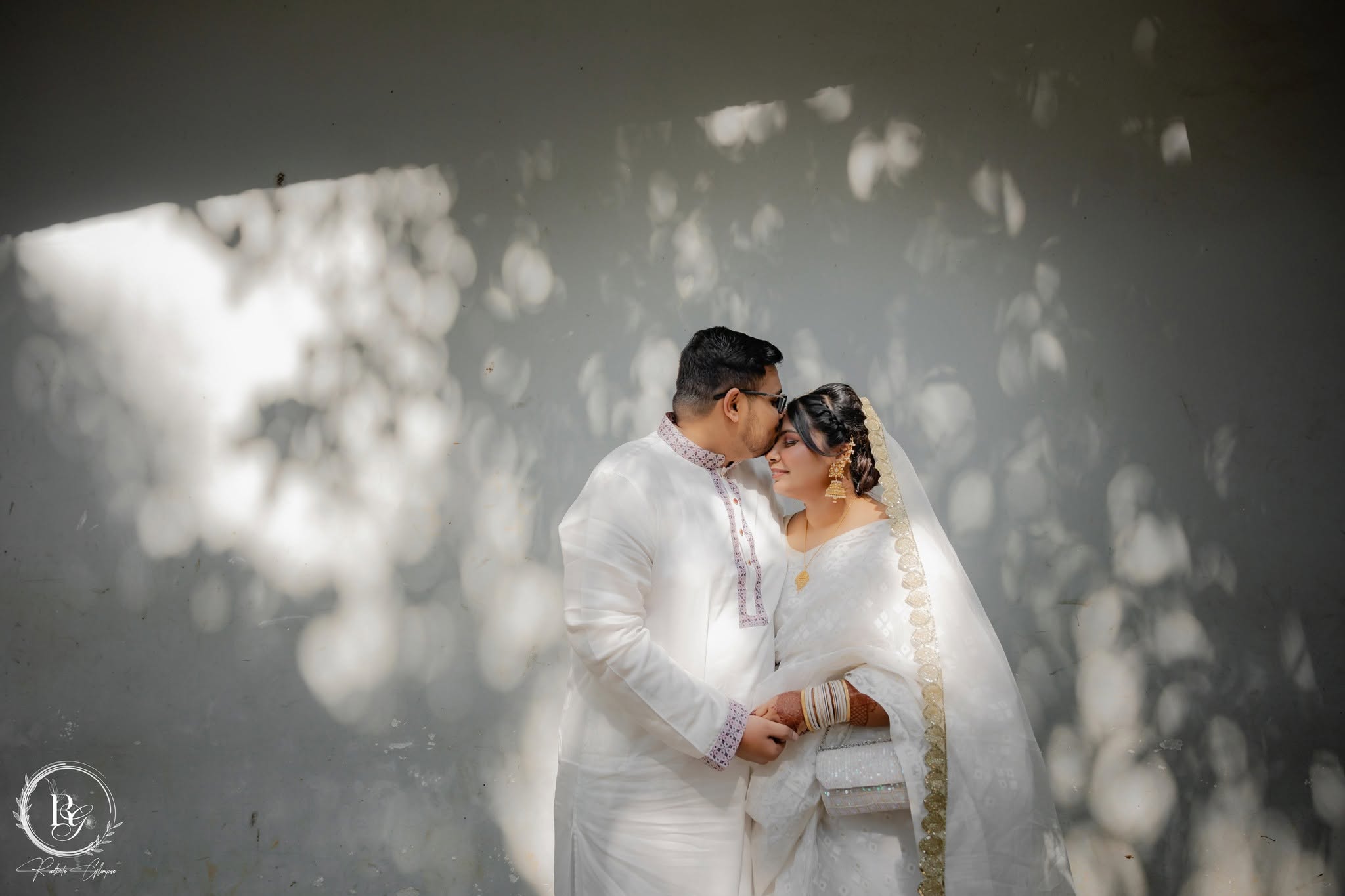 Couple in white — dappled light